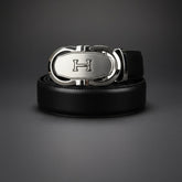 Black leather belt with a silver buckle on a dark gray background